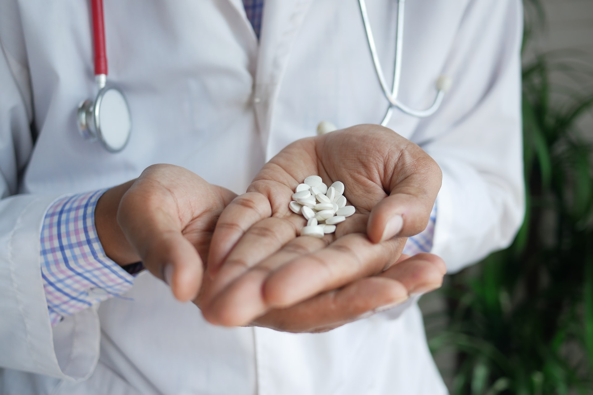 A doctor holding an un-prescribed group of drugs& medicine